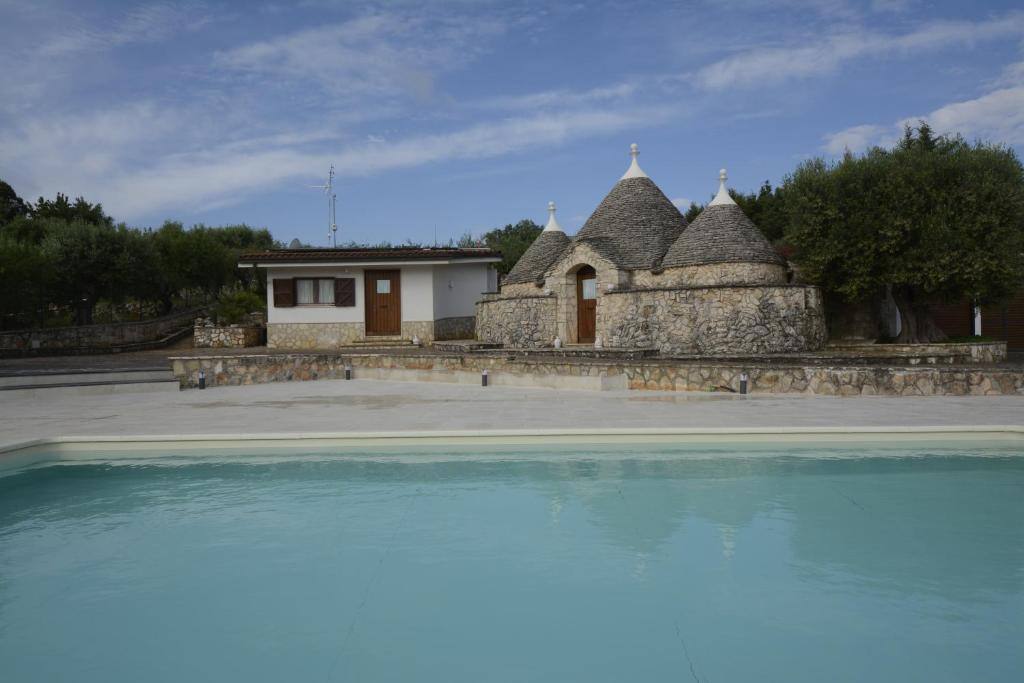 Trulli and swimming pool at I Trulli di Eva in Noci